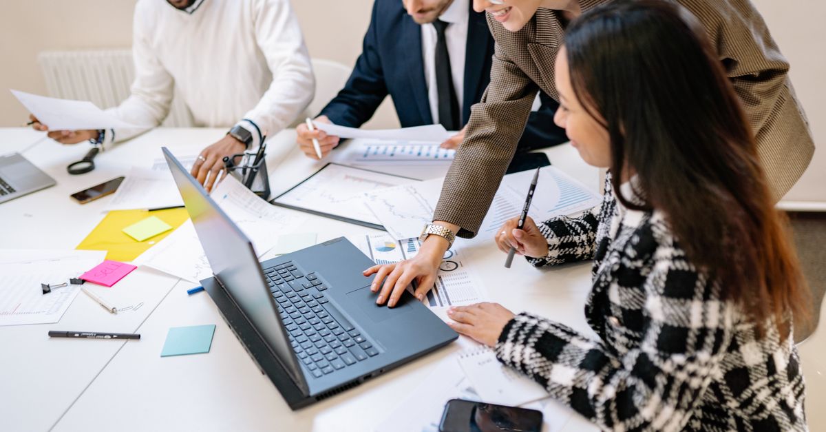 Diverse team working together on a project in a modern office environment.